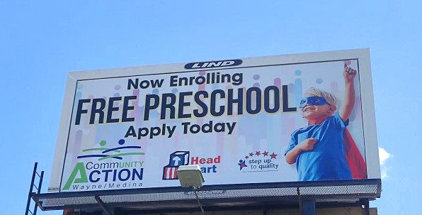 Photo of a Lind Billboard with a the design of a small child and the text "PreSchool Now Enrolling-Community Action Wayne/Medina"